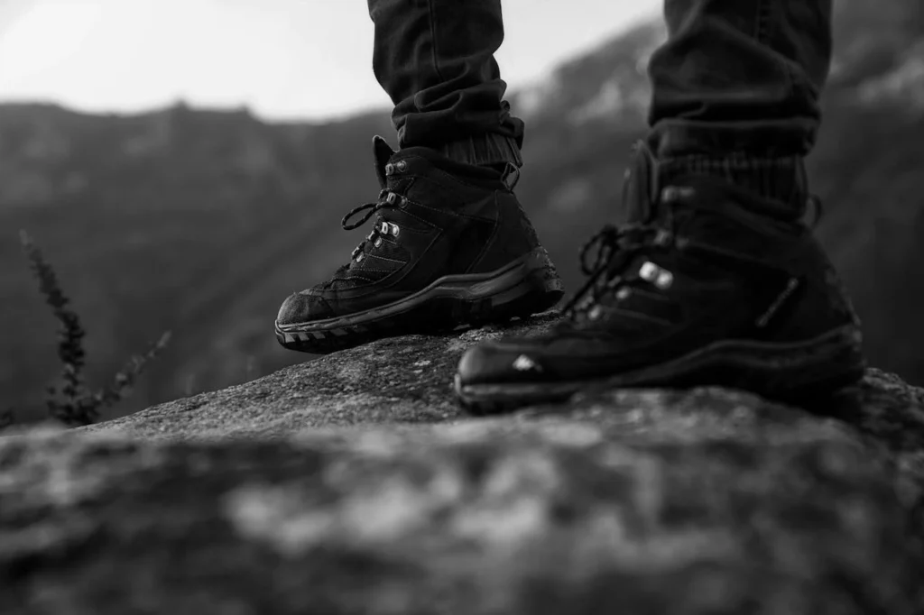 Close up of hiking boots on the steep, dusty scramble up to Fay Canyon Arch.